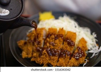 Japanese food called tonkatsu topped with delicious gravy or special tonkatsu sauce., Tonkatsu or Japanese deep fried pork cutlet can be found at Japanese restaurants.