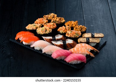 Japanese food nigiri and gunkans with fish, cottage cheese, vegetables. Set of nigiri and gunkans sushi with tuna, salmon, eel, sea bass, shrimp, tamago omelet, avocado and cucumber. - Powered by Shutterstock