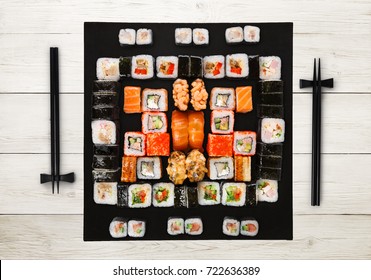 Japanese food restaurant delivery - sushi maki, unagi, gunkan and roll big party platter set on white wood background, above view