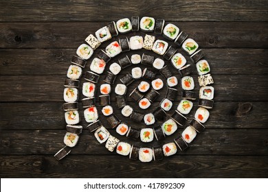 Japanese food restaurant, sushi maki roll plate or platter set. Maki Sushi rolls at rustic wood background. Top view, flat lay. Big party sushi set. 