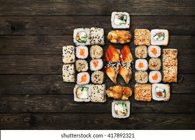 Japanese food restaurant, sushi maki gunkan roll plate or platter set. Unagi Sushi at rustic wood background. Top view, flat lay. Big party sushi set. 