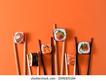 Japanese Food Various Sushi Roll Held With Chopstick On Light Background With Concept Poster Food Photography. 