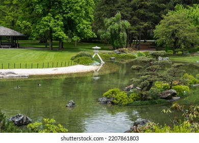 Japanese Garden At The Montreal Botanical Garden. Strolling Garden With Stone Lantern, Stream, Pond And Native Canadian Plants Arranged With  Japanese Aesthetics And Philosophical Ideas.  