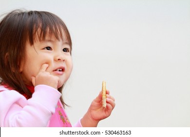 Japanese Girl Eating Rice Cracker (2 Years Old)