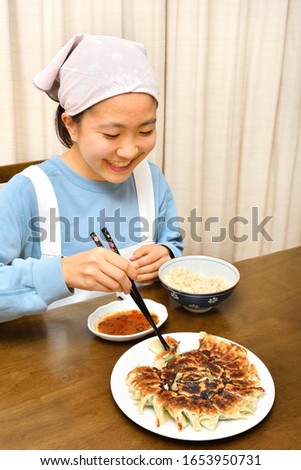 Japanese girl enjoys having Chinese dumplings