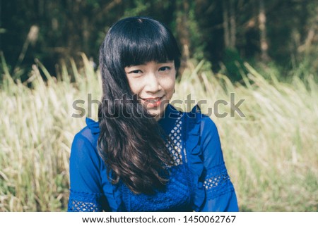 A Japanese girl is in a grassland in Hsinchu, Taiwan.
