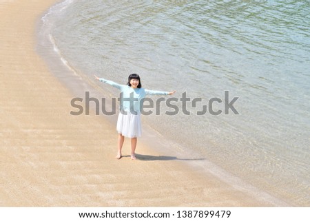 Japanese girl playing in the beach
