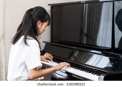 Japanese girl playing upright piano