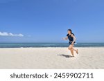 Japanese girl running in the beach in Pandanon Island in the Philippines Cebu