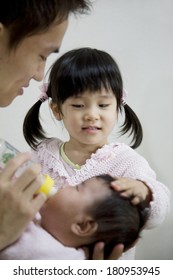 Japanese girl stroking her sister's hair