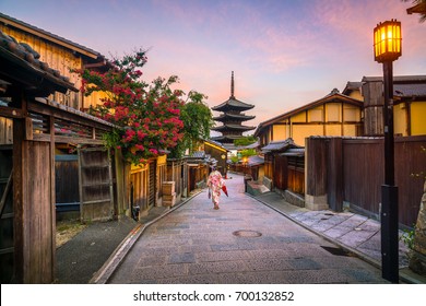 Japanese Girl In Yukata With Red Umbrella In Old Town  Kyoto, Japan