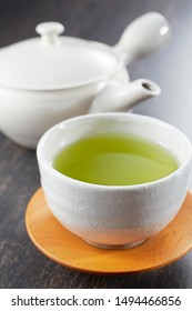 Japanese Green Tea With Pot On Wooden Table