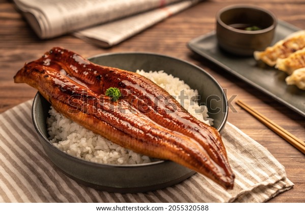 ๋Close-up Japanese\
grilled eel served over rice or Unagi don set on plate. Japanese\
food on restaurant\
table