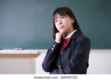 A Japanese Junior High School Girl Struggling In Her Classroom