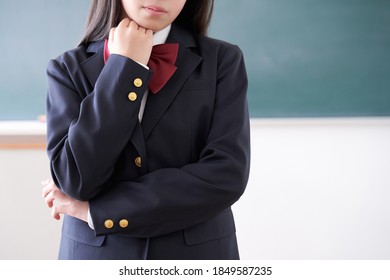 A Japanese Junior High School Girl Struggling In Her Classroom