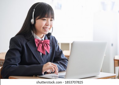 A Japanese junior high school girl takes a class on the computer in the classroom