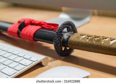 Japanese Katana Sword On A Computer Table In Office Room