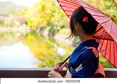 Japanese Kimono Woman With Traditional Red Umbrella