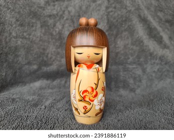 japanese kokeshi doll. Japanese figurine. Kokeshi (こけし, 小芥子) are simple wooden Japanese dolls with no arms or legs that have been crafted for more than 150 years as a toy for children.