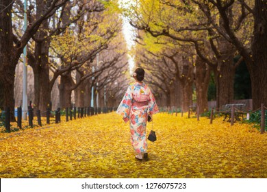Japanese lady walk in yollow Ginko avenue in Kimono dress, Tokyo city, Japan. This immage can use for travel, Autumn, Japan, and Tokyo concept
