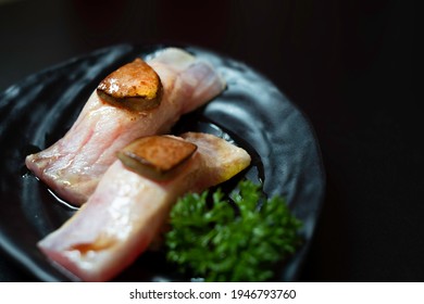Japanese maguro sushi topped with foie gras in Japanese restaurant. Eating Japanese food such as maguro sushi topped with froi gras is healthy. maguro fish sushi and Japanese food concept. Copy space.