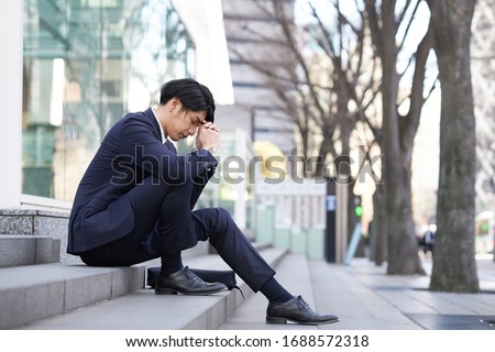 Japanese male businessmen suffering from anxiety.