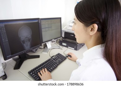 Japanese Male Doctor Looking At The Computer Monitor