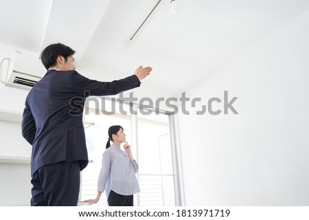 A Japanese male real estate salesman showing a house