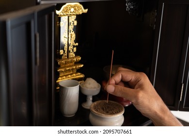 Japanese Man Giving Incense Sticks At Home