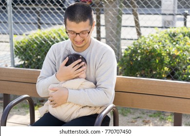 A Japanese man holding a child