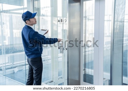 Japanese man inspecting the elevator