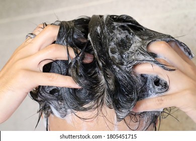 A Japanese Man Is Washing His Hair.