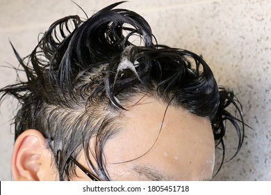 A Japanese Man Is Washing His Hair.