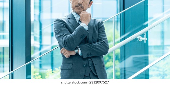 Japanese man wearing a suit to think - Powered by Shutterstock