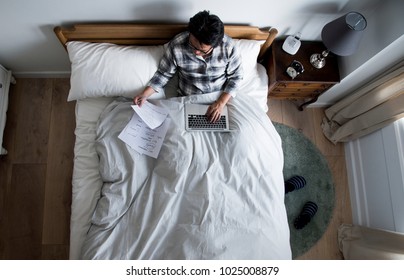 Japanese Man Working On Bed