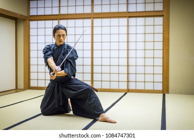 Japanese Martial Arts Athlete Training Kendo In A Dojo - Samaurai Practicing In A Gym