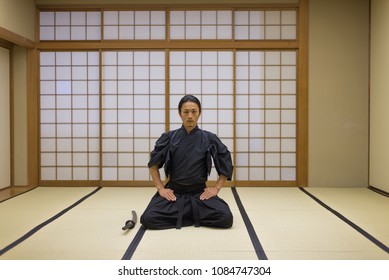 Japanese Martial Arts Athlete Training Kendo In A Dojo - Samaurai Practicing In A Gym