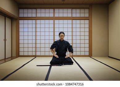 Japanese Martial Arts Athlete Training Kendo In A Dojo - Samaurai Practicing In A Gym