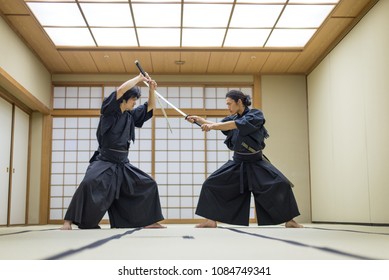 Japanese Martial Arts Athlete Training Kendo In A Dojo - Samaurai Practicing In A Gym