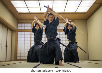 Japanese martial arts athlete training kendo in a dojo - Samaurai practicing in a gym