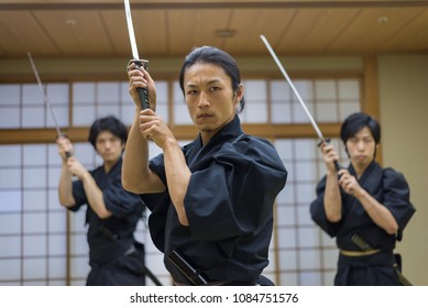 Japanese Martial Arts Athlete Training Kendo In A Dojo - Samaurai Practicing In A Gym