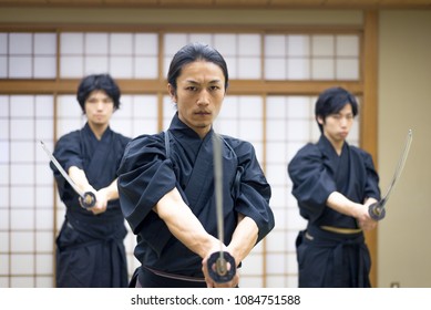 Japanese Martial Arts Athlete Training Kendo In A Dojo - Samaurai Practicing In A Gym