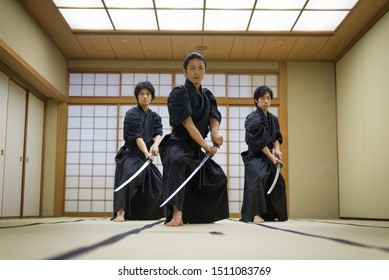 Japanese martial arts athlete training kendo in a dojo - Samaurai practicing in a gym - Powered by Shutterstock