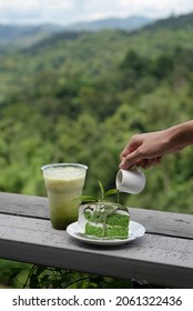 Japanese Matcha Green Tea Cake (chiffon Cake) And Green Tea On Wooden Balcony, Mountain Background 