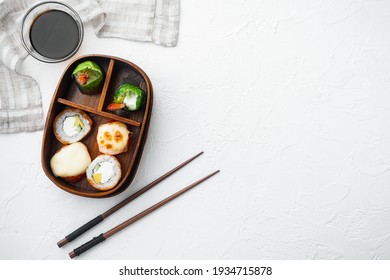 Japanese Meal In A Box Bento With Sushi Roll Eice Avocado Salmon Fish Set, On White Stone Background, Top View Flat Lay , With Copyspace And Space For Text