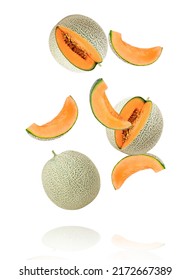 Japanese melon or cantaloupe (Cucumis melo) with cut slice flying in the air isolated on white background.