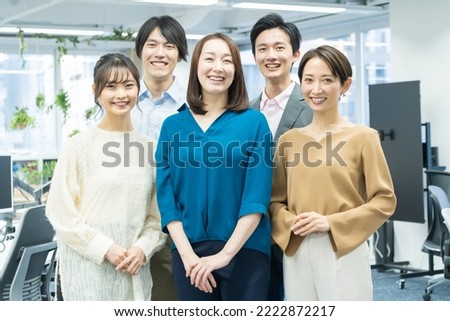 Japanese men and women looking at the camera with a smile