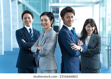 Japanese men and women in suits standing in the company lobby