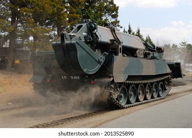 Japanese Military Engineering Vehicle Running On A Dirt Road.