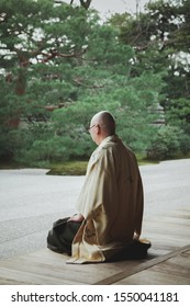 Japanese monk meditating in a Japanese garden. Kyoto, Japan.